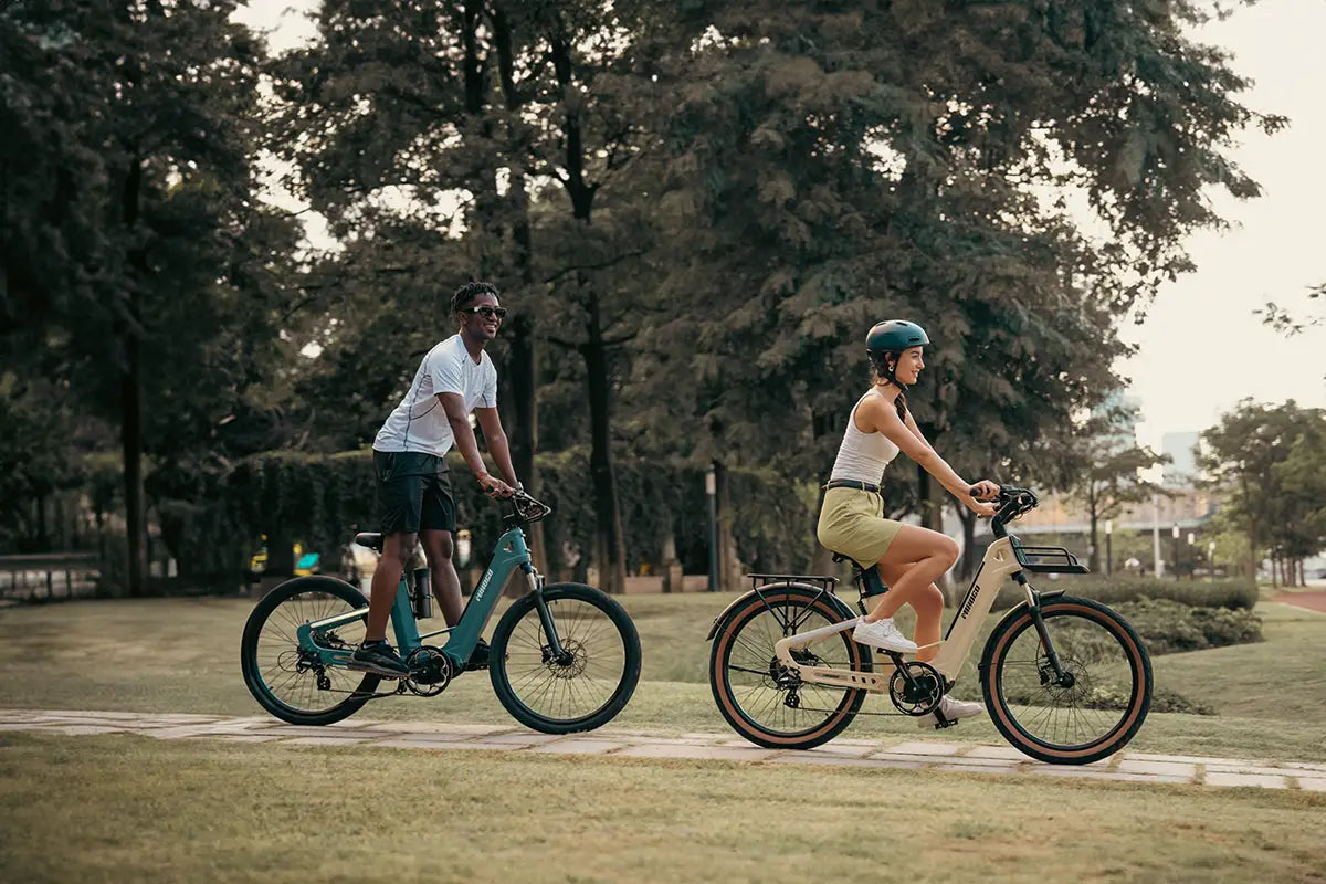 MIHOGO AIR step through electric bike, couple riding lightweight urban ebikes in city park, electric bicycles for leisure outdoor cycling